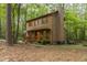 Wood-sided home with a covered front porch and chimney surrounded by lush greenery at 1012 King Cir, Chapel Hill, NC 27516
