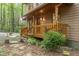 Inviting front porch with wooden railings and furniture, surrounded by well-maintained landscaping at 1012 King Cir, Chapel Hill, NC 27516