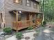 Inviting front porch with wood railings and gravel pathway leading up to the home, nestled in a wooded area at 1012 King Cir, Chapel Hill, NC 27516