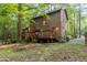 Back view of a charming home with a deck and wooded surrounding at 1012 King Cir, Chapel Hill, NC 27516