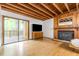 Open living room with hardwood floors, fireplace, and sliding glass doors to the outside at 1012 King Cir, Chapel Hill, NC 27516