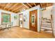 Inviting living area with wood floors, exposed beam ceiling and easy access to stairs at 1012 King Cir, Chapel Hill, NC 27516