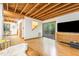 Bright living room with wood floors, exposed beam ceiling, and sliding glass doors at 1012 King Cir, Chapel Hill, NC 27516