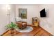 Cozy living room with hardwood floors, a reading chair, and a view of nature through the window at 1012 King Cir, Chapel Hill, NC 27516