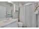 Clean bathroom with white vanity, closed shower and linen storage at 10330 Sablewood Dr # 104, Raleigh, NC 27617