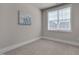 Simple bedroom with carpeted floors and a window for natural light at 10330 Sablewood Dr # 104, Raleigh, NC 27617