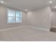 Neutral bedroom featuring a large window for ample natural light and carpet floors at 10330 Sablewood Dr # 104, Raleigh, NC 27617
