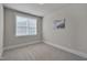 Neutral bedroom featuring carpeted floors and a large window with blinds at 10330 Sablewood Dr # 104, Raleigh, NC 27617