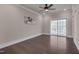 Spacious primary bedroom with hardwood floors, fan and sliding door to balcony at 10330 Sablewood Dr # 104, Raleigh, NC 27617
