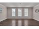 Spacious dining room features hardwood floors, crown molding, and natural light from three large windows at 10330 Sablewood Dr # 104, Raleigh, NC 27617