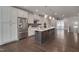 Open-concept kitchen features sleek cabinetry, a large island, and state-of-the-art stainless steel appliances at 10330 Sablewood Dr # 104, Raleigh, NC 27617
