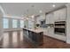 Modern kitchen with stainless steel appliances, spacious island, and stylish lighting fixtures at 10330 Sablewood Dr # 104, Raleigh, NC 27617