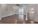 Bright, open living room with hardwood floors and balcony access, perfect for relaxing or entertaining at 10330 Sablewood Dr # 104, Raleigh, NC 27617