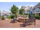 Outdoor lounge area featuring grills, a fire pit, and seating benches at 10330 Sablewood Dr # 104, Raleigh, NC 27617