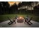 Backyard fire pit with chairs in a large backyard surrounded by tall mature trees at 1050 Southern High School Rd, Burlington, NC 27215