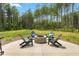 Backyard fire pit with chairs in a large backyard surrounded by tall mature trees at 1050 Southern High School Rd, Burlington, NC 27215
