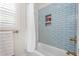 Shower with blue subway tile, recessed shelving and brushed gold shower head at 1050 Southern High School Rd, Burlington, NC 27215