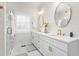 Bright bathroom showcasing a dual vanity with gold hardware, a glass enclosed shower, and a marble countertop at 1050 Southern High School Rd, Burlington, NC 27215