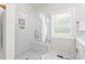 Elegant bathroom features a glass enclosed shower with white marble surround, built in storage, and chrome hardware at 1050 Southern High School Rd, Burlington, NC 27215