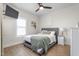 Cozy bedroom with a ceiling fan, stylish decor, comfortable bed, and natural light at 1050 Southern High School Rd, Burlington, NC 27215