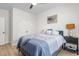 Cozy bedroom with luxury vinyl floors, a ceiling fan, a queen-size bed with blue bedding, and shuttered window at 1050 Southern High School Rd, Burlington, NC 27215