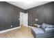 Stylish bonus room featuring luxury vinyl floors, wainscotting, and a gray sofa at 1050 Southern High School Rd, Burlington, NC 27215