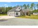 Charming exterior with stone accents, black shutters, and a spacious driveway at 1050 Southern High School Rd, Burlington, NC 27215