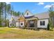 Beautiful exterior with stone accents, wood porch supports, and lush landscaping at 1050 Southern High School Rd, Burlington, NC 27215