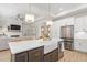 Open-concept kitchen with island, farmhouse sink, stainless steel appliances, and seamless access to living area at 1050 Southern High School Rd, Burlington, NC 27215