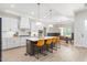 Modern kitchen featuring a large island with seating and an adjacent dining area at 1050 Southern High School Rd, Burlington, NC 27215