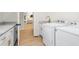 Convenient laundry room with white front load washer and dryer, granite countertops, and white cabinets at 1050 Southern High School Rd, Burlington, NC 27215