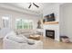 Bright living room featuring a fireplace, wood floors, and comfortable sectional sofa at 1050 Southern High School Rd, Burlington, NC 27215