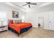 Bright main bedroom featuring a tray ceiling, fan, and ample natural light through shuttered windows at 1050 Southern High School Rd, Burlington, NC 27215