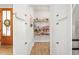 Walk-in pantry featuring a wooden door and fully stocked shelving, providing ample storage at 1050 Southern High School Rd, Burlington, NC 27215