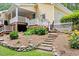 Well-maintained backyard with stone steps leading to a tiered deck, surrounded by vibrant flowers and lush greenery at 106 Autumn Cir, Cary, NC 27518