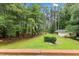 Enjoy serene backyard views from the deck, featuring a lush lawn, mature trees, and a charming outbuilding at 106 Autumn Cir, Cary, NC 27518