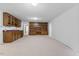 Basement featuring carpet, a wet bar, built-in shelving, and ample space for entertainment at 106 Autumn Cir, Cary, NC 27518