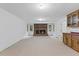 Spacious basement area featuring carpet, a charming brick fireplace, wet bar, and natural light at 106 Autumn Cir, Cary, NC 27518