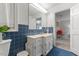 Vintage blue-tiled bathroom with a white sink vanity and classic fixtures providing a unique charm at 106 Autumn Cir, Cary, NC 27518