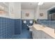 Stylish bathroom with blue tiling, offering a clean aesthetic, along with a sink and toilet at 106 Autumn Cir, Cary, NC 27518