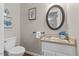Bright bathroom featuring a white toilet, single vanity, and decorative wall art at 106 Autumn Cir, Cary, NC 27518