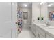 Bright bathroom featuring a white vanity, patterned shower curtain, and a window providing natural light at 106 Autumn Cir, Cary, NC 27518