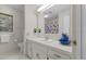 Functional bathroom with a large mirror, white fixtures, and a window bringing in natural light at 106 Autumn Cir, Cary, NC 27518