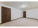Bedroom with neutral carpet, a drop ceiling and wood trim doors at 106 Autumn Cir, Cary, NC 27518