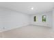 Bright bedroom featuring carpet, shiplap wall, and windows bringing the outside in at 106 Autumn Cir, Cary, NC 27518