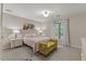 Comfortable bedroom with a brightly upholstered bench, a large window, and neutral decor at 106 Autumn Cir, Cary, NC 27518