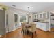 Dining room with bay window, hardwood floors, and built-in cabinets at 106 Autumn Cir, Cary, NC 27518