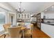 Cozy dining area with hardwood floors, bay window and chandelier lighting at 106 Autumn Cir, Cary, NC 27518