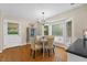 Sunlit dining room features hardwood floors, bay window, and chandelier at 106 Autumn Cir, Cary, NC 27518