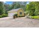 Charming home exterior with a driveway and garage, complemented by well-manicured landscaping and mature trees at 106 Autumn Cir, Cary, NC 27518